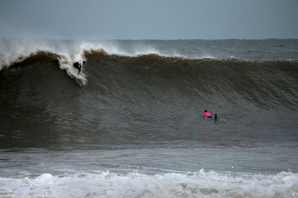 surfers at Cayton bay